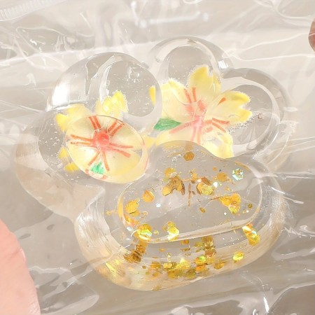 Jucarie Antistres Squishy, Flippy, Labuta de Pisica Pufoasa, cu Revenire Lenta, 7 x 6.5 cm, Model Flori 2, Transparent