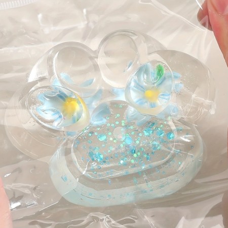 Jucarie Antistres Squishy, Flippy, Labuta de Pisica Pufoasa, cu Revenire Lenta, 7 x 6.5 cm, Model Flori 2, Transparent